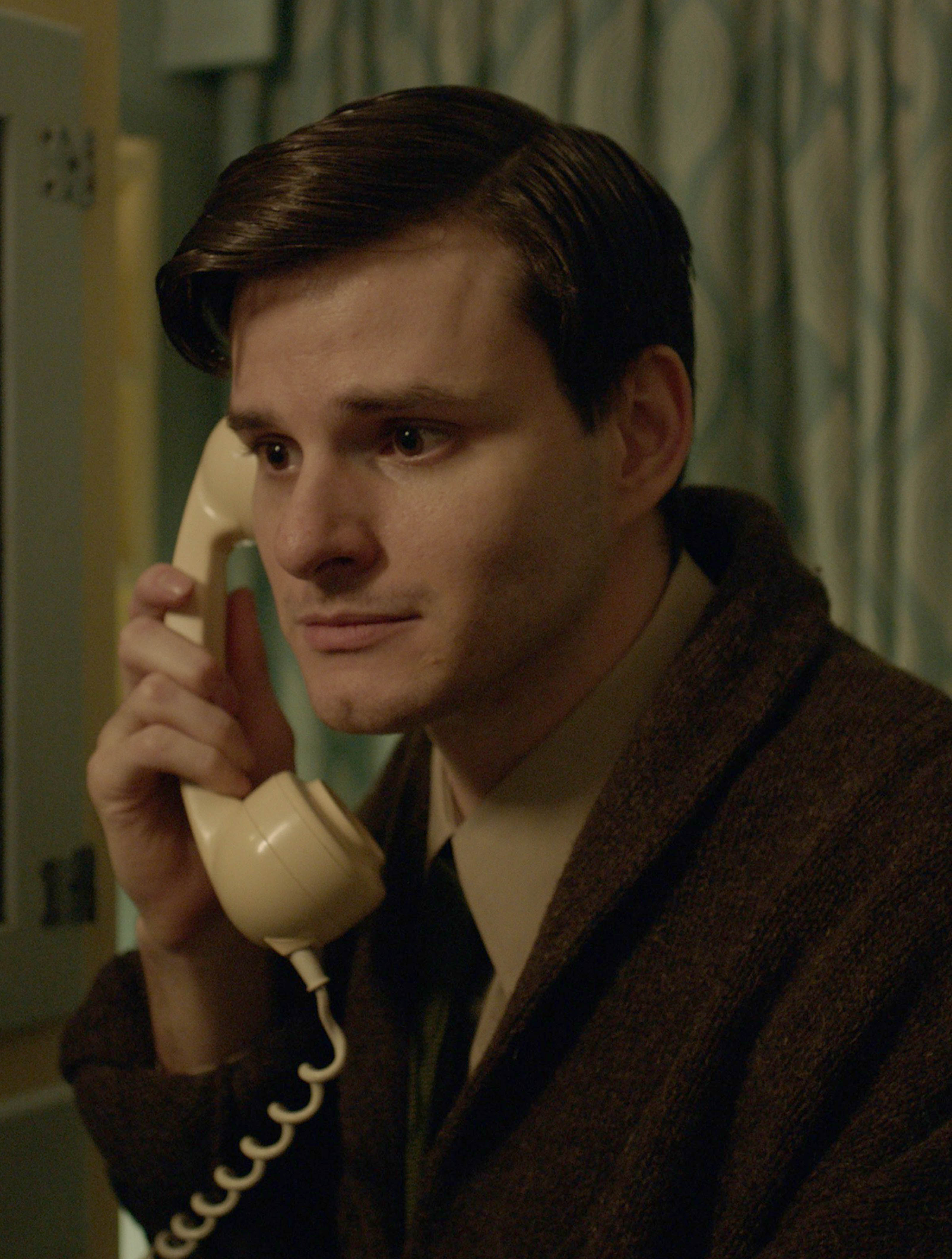 Sam Hume in period costume on the phone